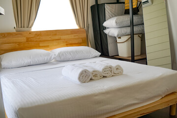 Guest Bedroom with Rolled Towels and Natural Light