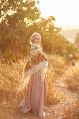 girl on the field in the evening. girl of Slavic appearance in a beautiful place