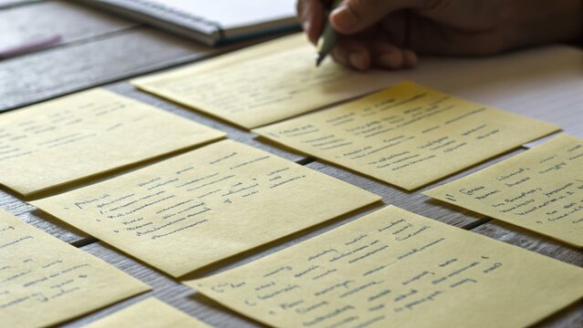 Organized indian startup community brainstorming session with handwritten notes on yellow paper for creative planning and teamwork