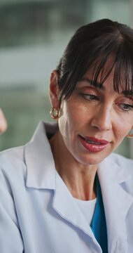 Conversation, doctor and woman in meeting, feedback and coaching with surgery schedule. Mature person, medical service and professional in clinic, discussion and healthcare facility with mento