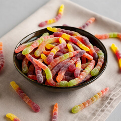 Sugary Sour Gummy Worms in a Bowl, side view.