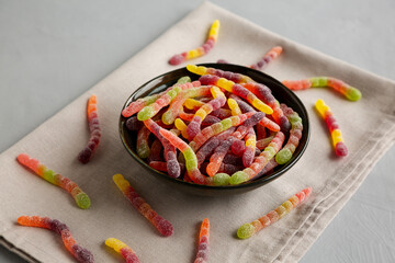 Sugary Sour Gummy Worms in a Bowl, side view.