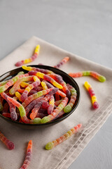 Sugary Sour Gummy Worms in a Bowl, side view.