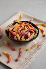 Sugary Sour Gummy Worms in a Bowl, side view.