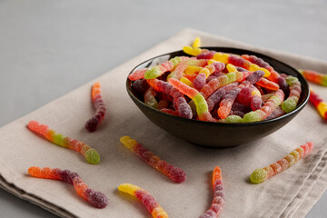 Sugary Sour Gummy Worms in a Bowl, side view.