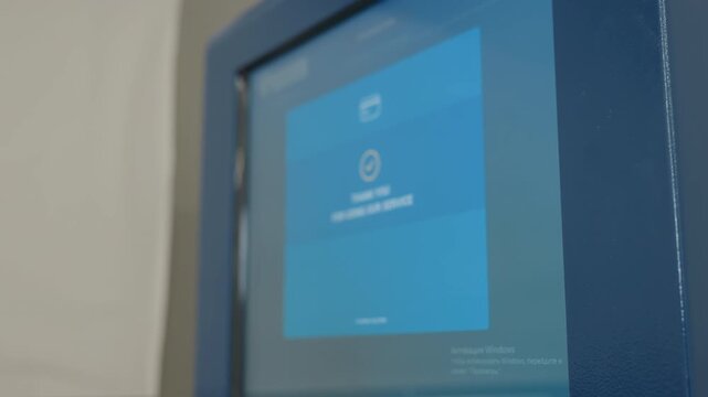 Close up payment machine screen showing digital interface with blue background displaying thank you for using service message, electronic checkout terminal display in operation