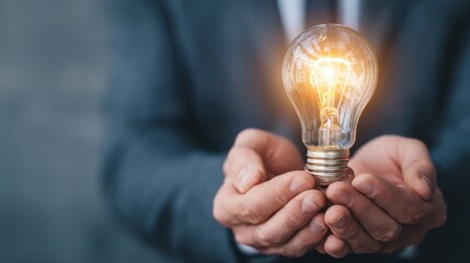 Bright Idea Conceptualization Creative Thought Handheld Light Bulb Inspiration in Blue Background