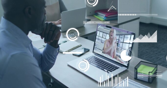 Displaying laptop streaming remote attendee with dashboard at office, colleagues in business attire