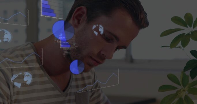 Leaning man wearing striped shirt analyzing digital charts at office desk, with potted plant