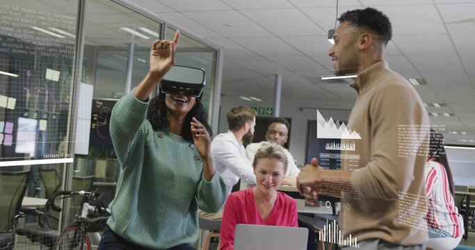 Interacting Hispanic woman with VR headset reaching for holographic charts in office, copy space