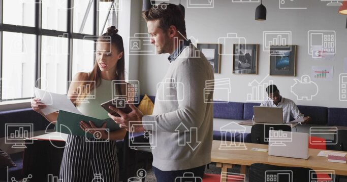 Reviewing papers, coworkers standing by grid window in office lounge, with green folder, laptop - Powered by Adobe