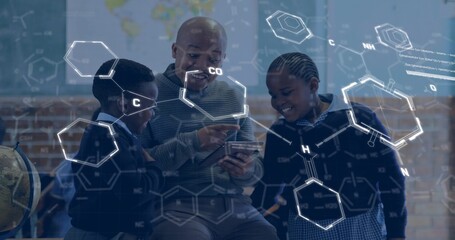 Pointing teacher and kids exploring science on tablet in lab, with globe, map and floating formulas