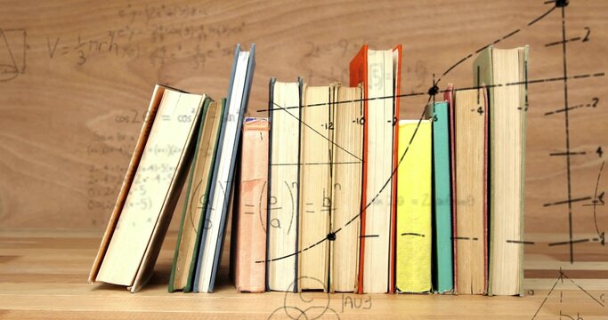 Fototapeta Displaying row of hardcover books standing on wooden surface in study, overlaid with math diagrams
