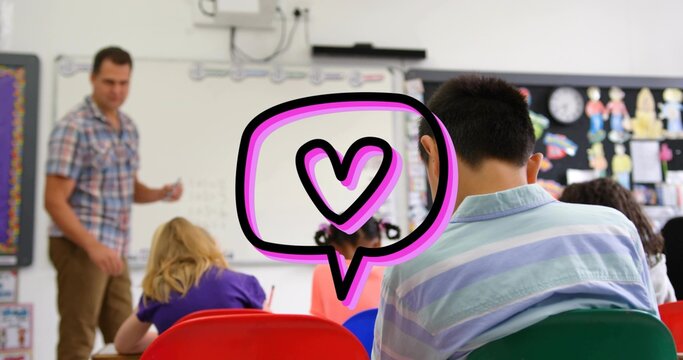 Facing student wearing striped polo shirt at classroom desk, watching teacher writing whiteboard