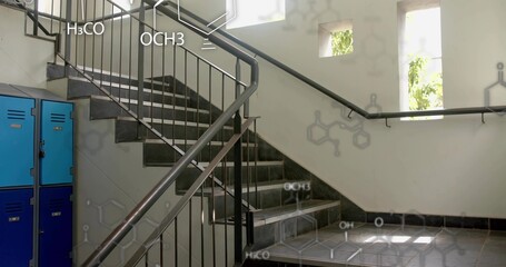 Featuring U-shaped grey tiled staircase in lab stairwell, with blue lockers and chemical formulas