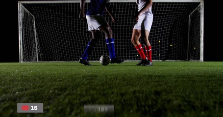 Dueling players under lights, with soccer ball, goal net, red record icon overlay, on-screen timer