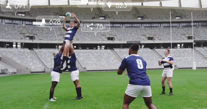 Lifting rugby jumper catching ball on stadium pitch, with goal posts, striped jerseys and cleats