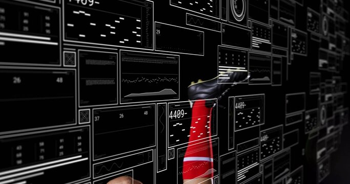 Extending athlete lower leg in lab among floating data panels, with red sock, black cleated shoe