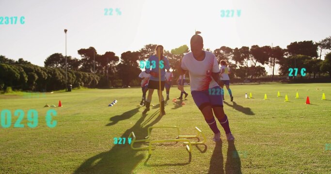 Sprinting female soccer player performing hurdle drill at golden hour grass pitch, with cones