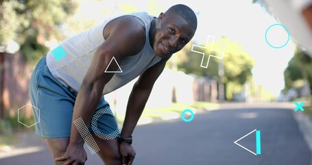 Pausing runner bending hands-on-knees on suburban street, wearing athletic wear, watch, overlays