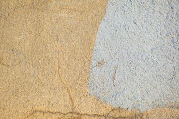 Abstract texture of yellow and white painted wall with crackles
