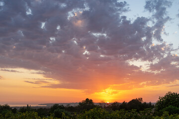 A dramatic Portuguese sunset paints the sky in gold and crimson as the sun dips below the horizon