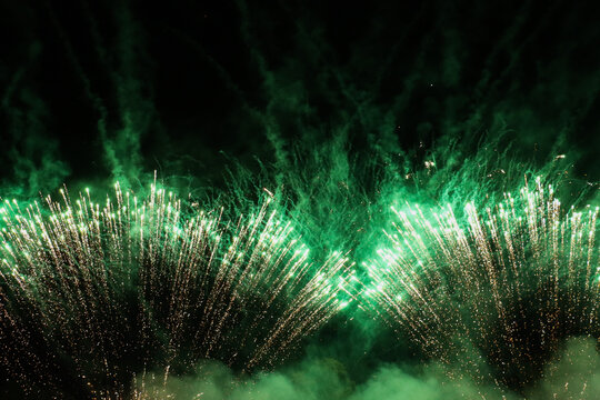 Bright Green Fireworks Exploding in the Night Sky