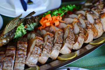 Deliciously sliced roast meat platter with colorful garnish