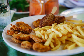 Crispy chicken nuggets and golden fries on a plate