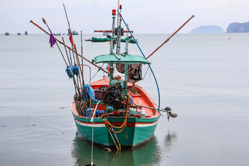 Authentic Thai local fishing vessel at anchor — weathered paint, ropes, and equipment tell a story of coastal life, perfect for travel or cultural storytelling.