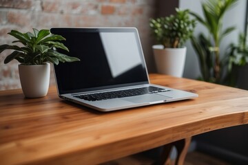 Fototapeta premium Wooden table with laptop blank white screen, complemented by a vibrant potted plant