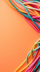 Bundles of colorful ropes create a vibrant abstract pattern against a plain background, suggesting imagination and diversity.