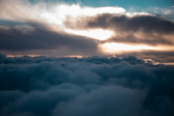 Obraz premium view from the airplane window to mountains clouds and blue sky