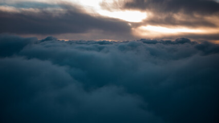 view from the airplane window to mountains clouds and blue sky