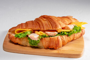 Delicious croissant sandwich filled with fresh ingredients and savory flavors awaits to be enjoyed