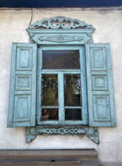 Window and shutters on the wall of the house