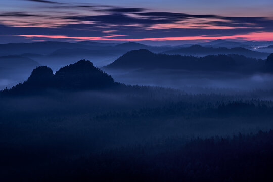 Night view on Kleiner Winterberg, S&auml;chsische Schweiz, Germany autumn landscape. Travel in Europe. Misty foggy morning sunride nature. Rock hills with trees and forest. Misty night in Saxon Switzerland