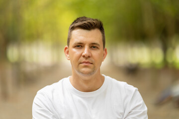 Young man with serious expression looking directly at camera