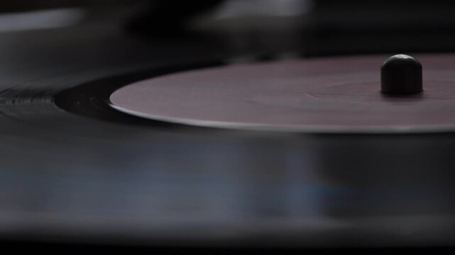 macro vinyl record spinning in turntable, vintage vinyl record playing music