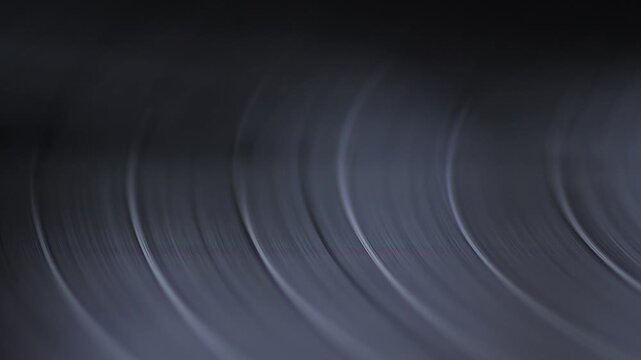 Spinning vinyl record in turntable macro, vintage vinyl record, retro audio equipment concept