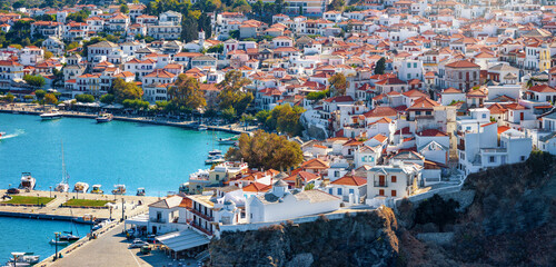 Aerial view of the architecture of Skopelos town, Sporades, Greece, with white houses and red roofs situated on a hillside