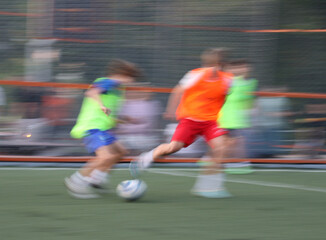 teens boys plays football at a sports school .Blur