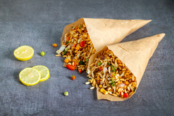 "Jhalmuri", a spicy Bengali street snack made with puffed rice, mustard oil, onions, chilies, and tangy spices for crunch and flavor.
