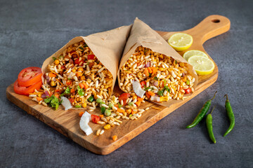 "Jhalmuri", a spicy Bengali street snack made with puffed rice, mustard oil, onions, chilies, and tangy spices for crunch and flavor.
