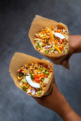 "Jhalmuri", a spicy Bengali street snack made with puffed rice, mustard oil, onions, chilies, and tangy spices for crunch and flavor.
