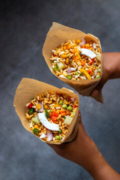 "Jhalmuri", a spicy Bengali street snack made with puffed rice, mustard oil, onions, chilies, and tangy spices for crunch and flavor.
