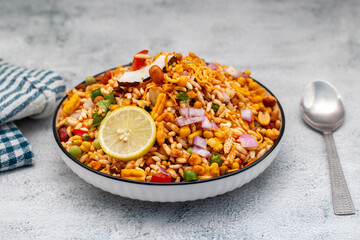 "Jhalmuri", a spicy Bengali street snack made with puffed rice, mustard oil, onions, chilies, and tangy spices for crunch and flavor.
