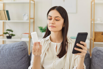 Woman searching information about pills in internet, reading instruction about medicaments...