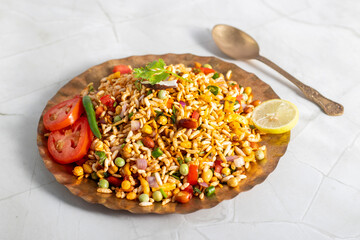 "Jhalmuri", a spicy Bengali street snack made with puffed rice, mustard oil, onions, chilies, and tangy spices for crunch and flavor.
