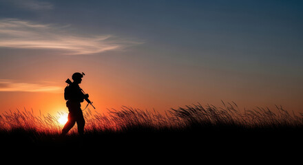 Hunter silhouetted against golden sunset field